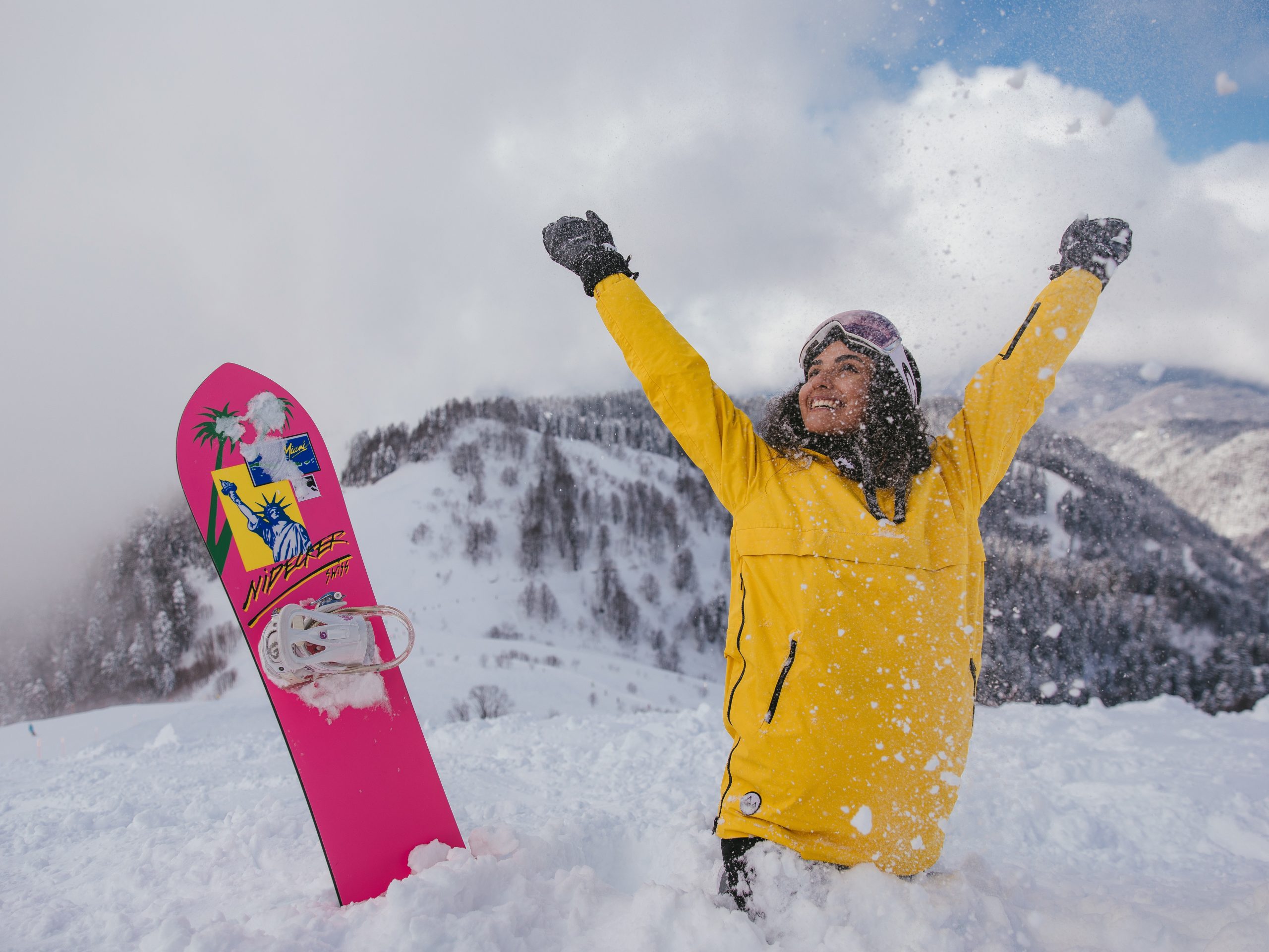 Bright Yellow Jacket and Red Snowboarding Pants for an Active Snow Day — Snow Day Outfits