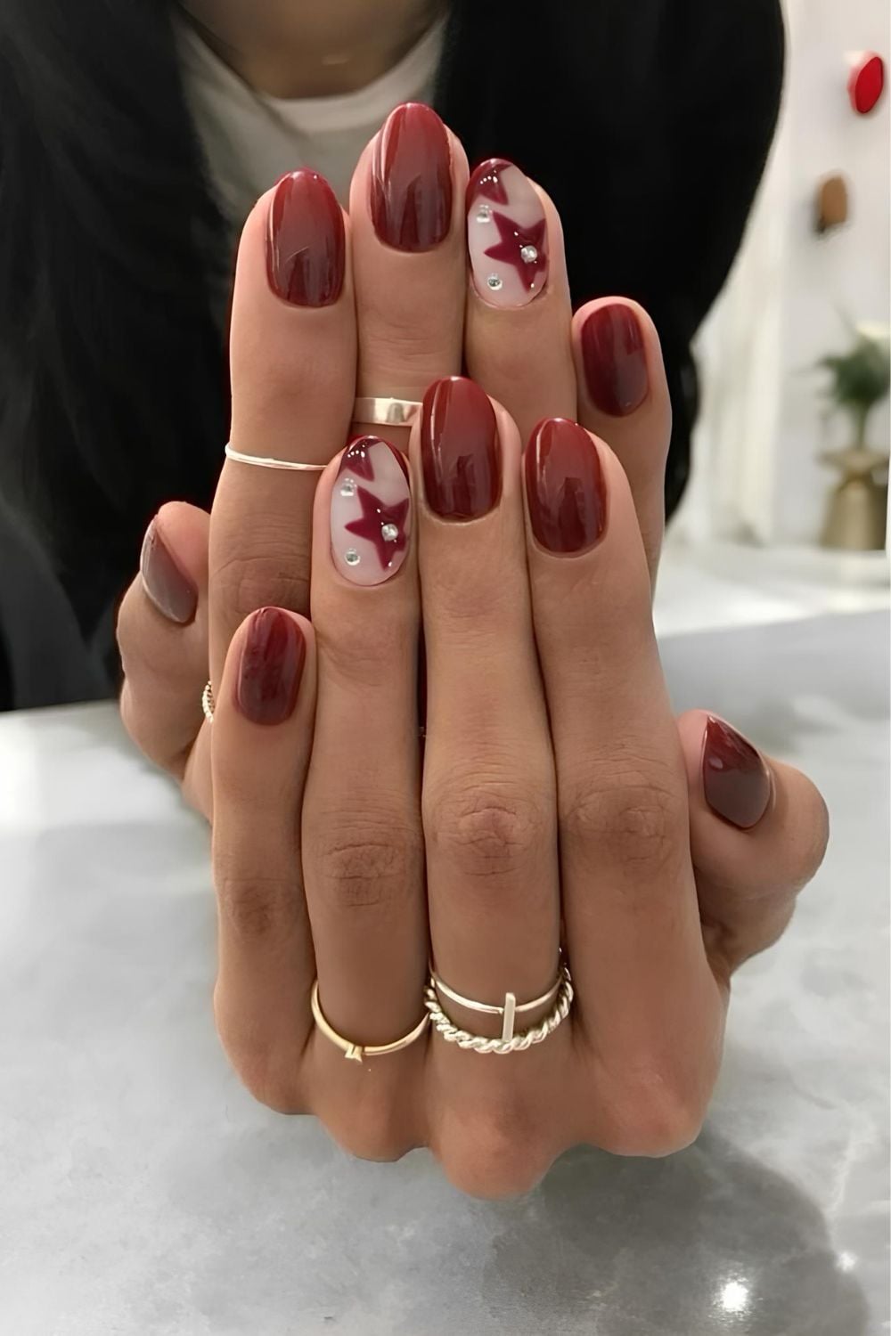 Deep Red Oval with Leaf Art and Rhinestones — January Nails