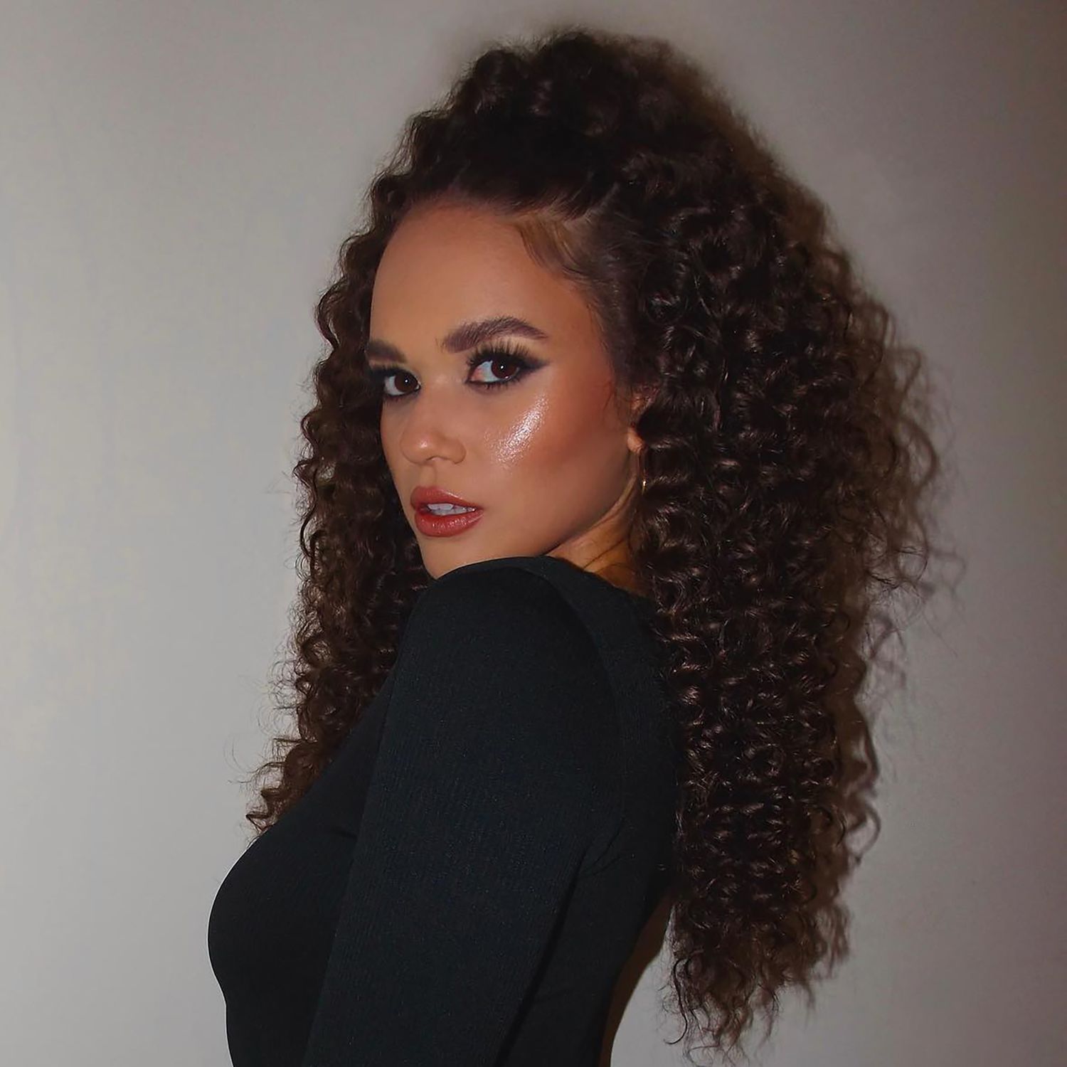 High Voluminous Dark Brown Ponytail — Winter Hairstyles for Curly Hair