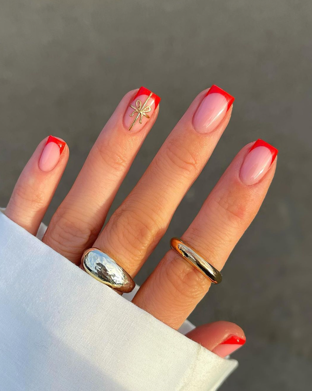 Sheer Pink French Tips with Gold Bow Accent Sheer Pink French Tips with Gold Bow Accent — Winter Nail Colors for Women Over 40