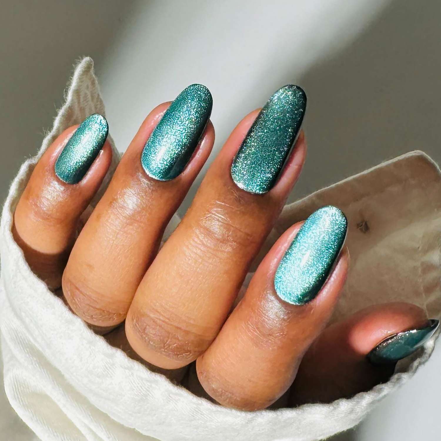 Shimmering Teal Glitter Oval Nails Shimmering Teal Glitter Oval Nails — Winter Nail Colors for Women Over 50