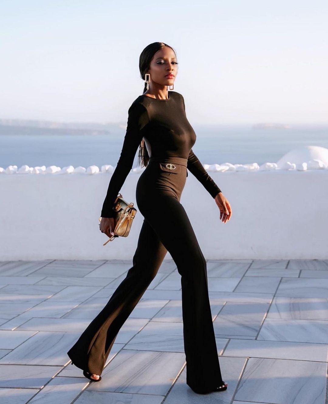 Longline Quilted Coat Over Fitted Top and Wide-Leg Trousers — All Black Winter Outfits