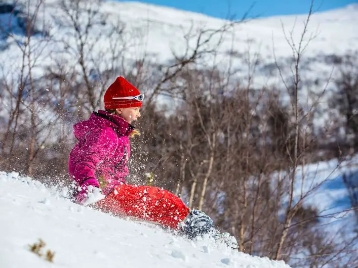 Bright Pink Winter Coat and Red Pants for Sledding Fun — Winter Outfits for Kids