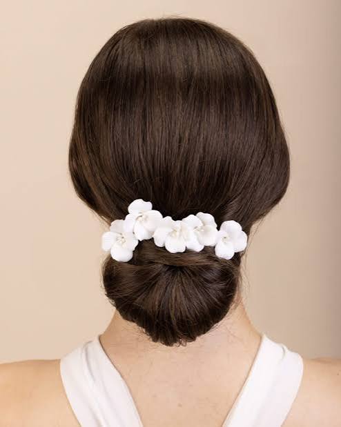 Mid-Back Dark Brown Low Bun With Floral Accessory Mid-Back Dark Brown Low Bun With Floral Accessory — Winter Wedding Hairstyles