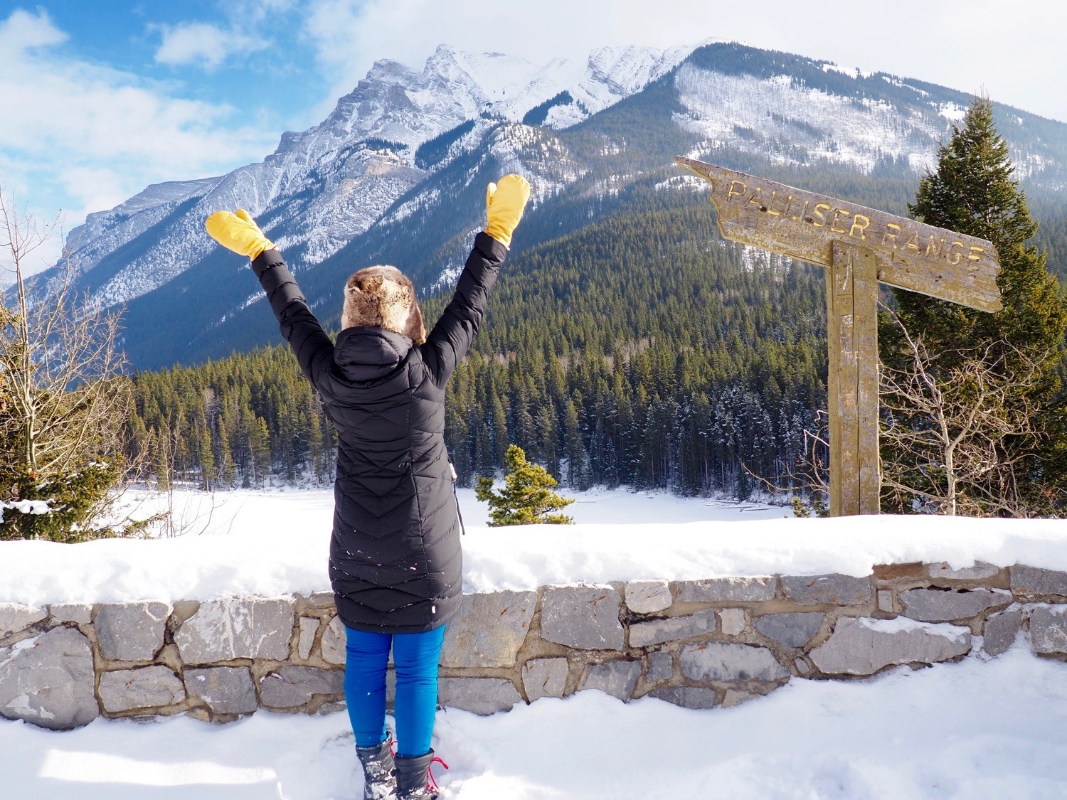 Black Puffer Coat and Bright Mittens for Snowy Adventures — Winter Travel Outfits