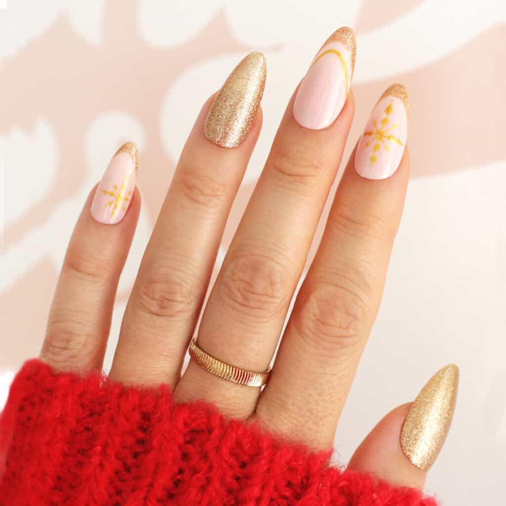 Pale Pink with Gold Glitter Tips and Snowflake Pale Pink with Gold Glitter Tips and Snowflake — Winter Almond Nails