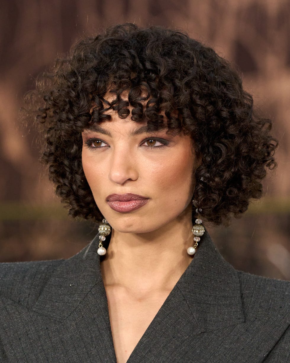 Short Curly Dark Brown Hair with Grey Blazer and Pearls Short Curly Dark Brown Hair with Grey Blazer and Pearls — Trendy Haircuts for Women
