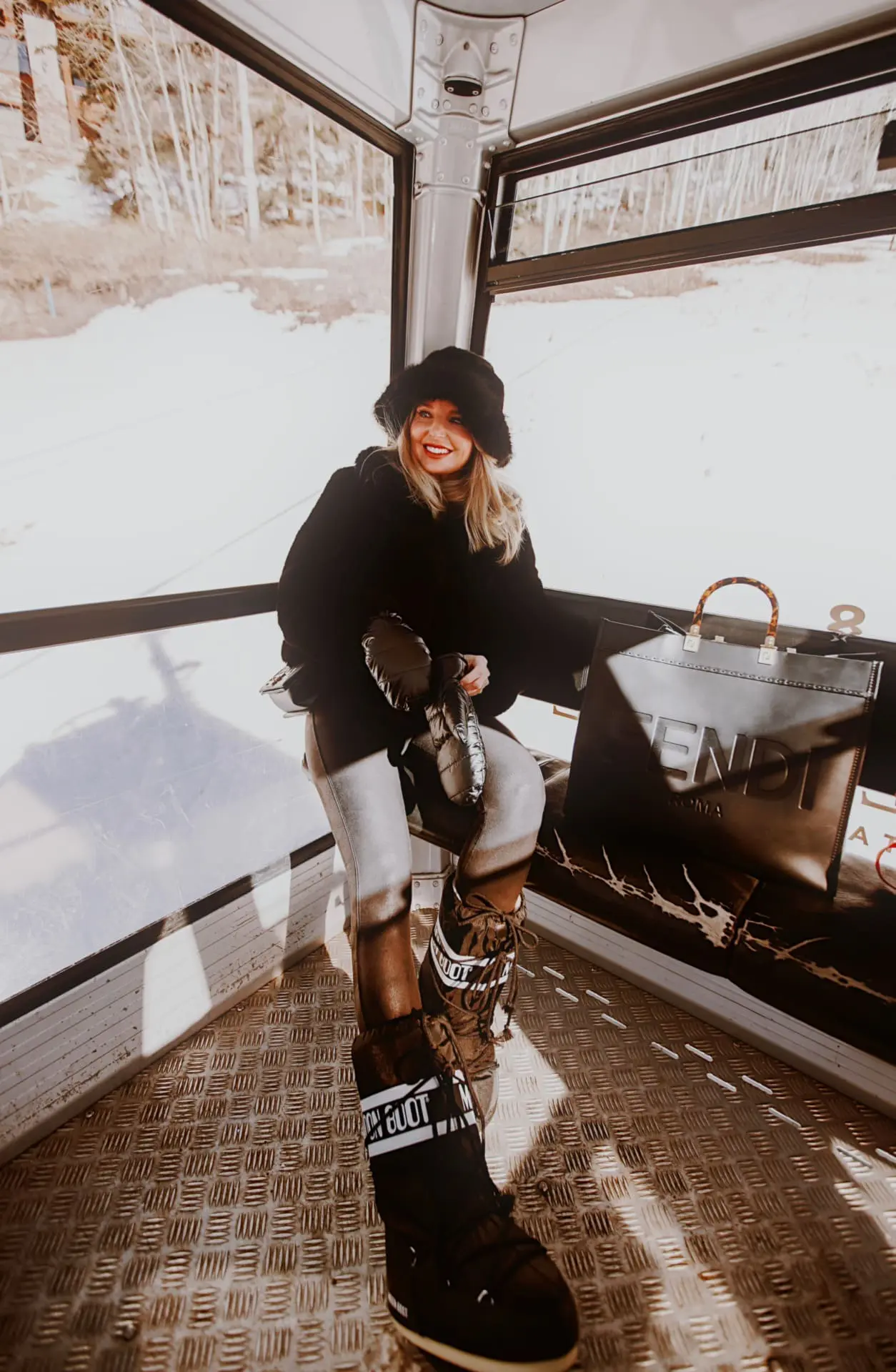 Black Fur Jacket and Grey Trousers with Brown Moon Boots for Apres Ski Black Fur Jacket and Grey Trousers with Brown Moon Boots for Apres Ski — Apres Ski Outfits