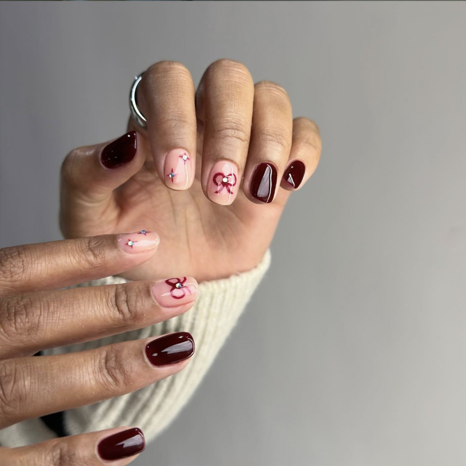 Short Burgundy Nails with Red Bow Accents Short Burgundy Nails with Red Bow Accents — Winter Nail Colors for Women Over 40