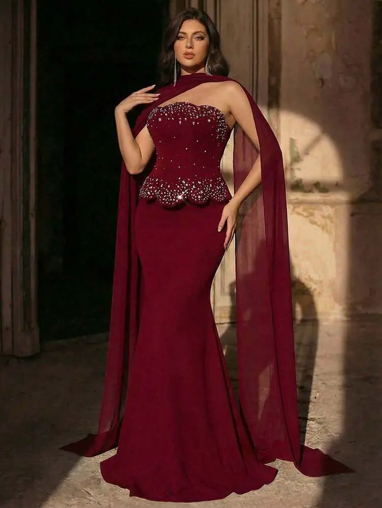 Burgundy Mermaid Gown with Asymmetric Neckline and Sheer Cape Burgundy Mermaid Gown with Asymmetric Neckline and Sheer Cape — Winter Formal Dresses