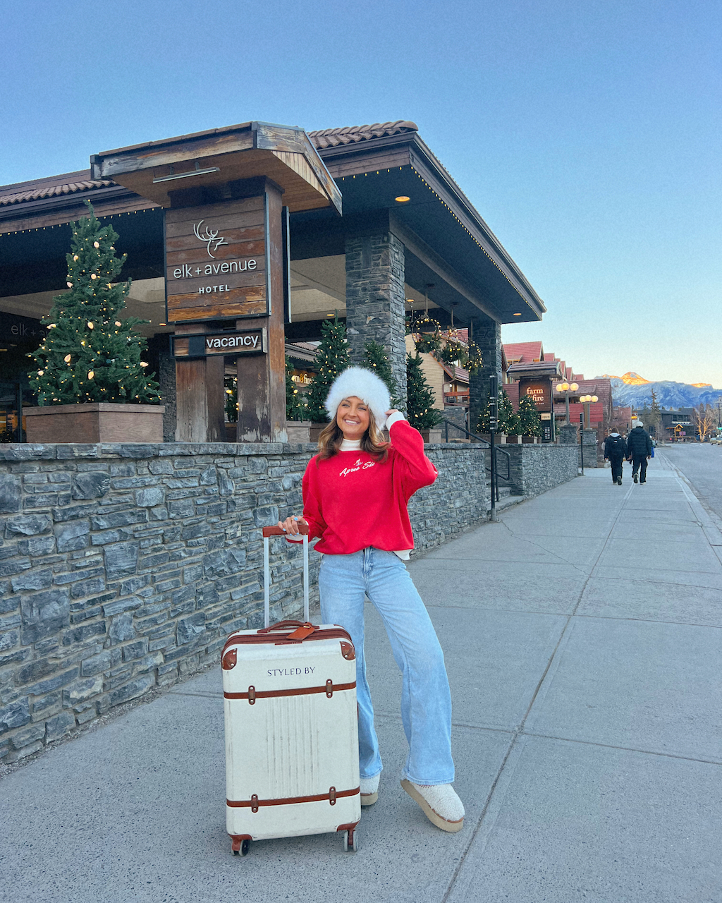 Festive Red Sweatshirt and Wide-Leg Jeans for Cozy Travel — Winter Travel Outfits