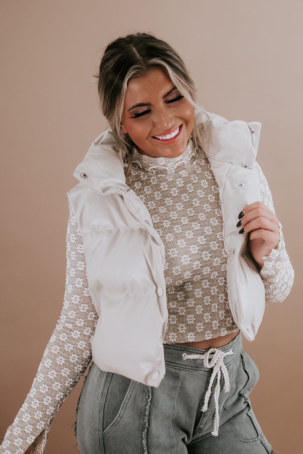 Cropped Cream Puffer Vest Over Patterned Top Cropped Cream Puffer Vest Over Patterned Top — Puffer Vest Outfits
