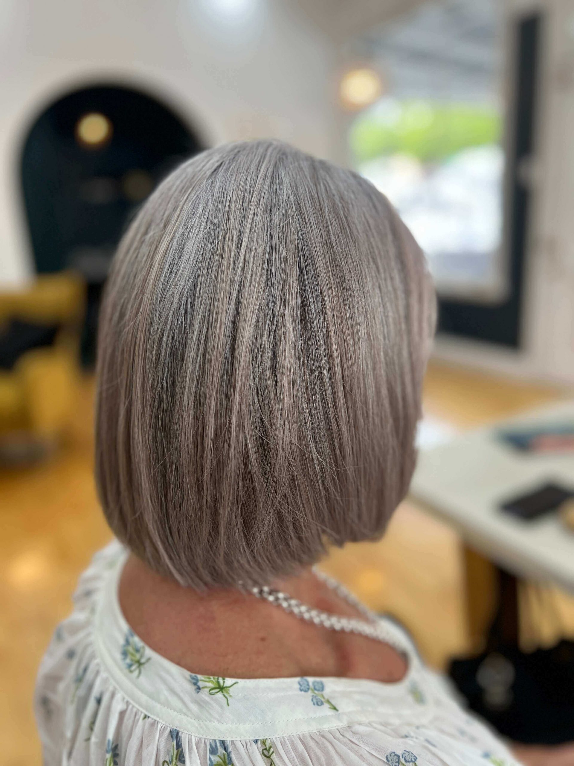 Back View Chin-Length Bob With Blended Gray Tones Back View Chin-Length Bob With Blended Gray Tones — Gray Blending Highlights