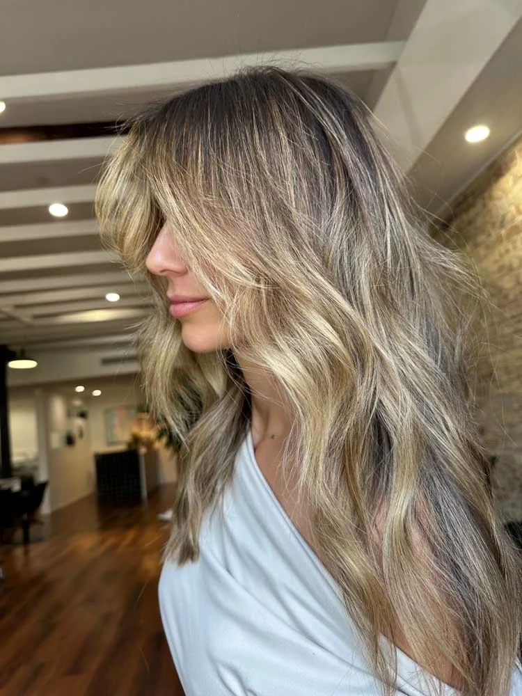 Dark Blonde With Highlights Collarbone Layered Blowout With Curtain Bangs Dark Blonde With Highlights Collarbone Layered Blowout With Curtain Bangs — Winter Layered Haircuts