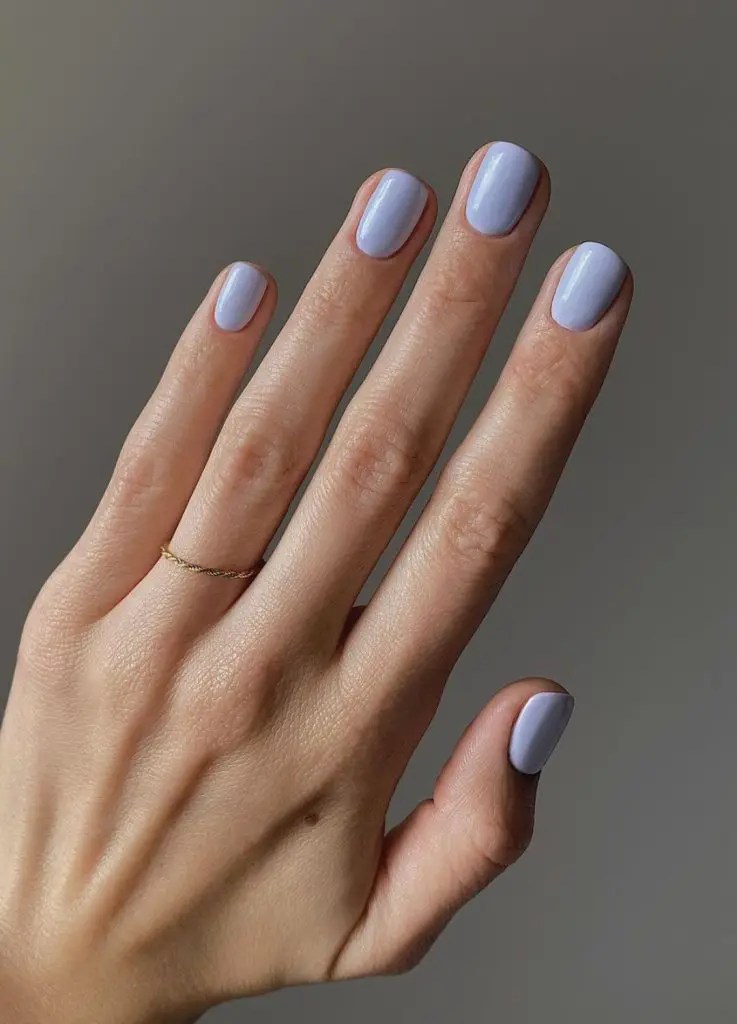 One Hand Close Up Light Periwinkle Blue Glossy Short Oval Nails One Hand Close Up Light Periwinkle Blue Glossy Short Oval Nails — Winter Nail Colors for Pale Skin