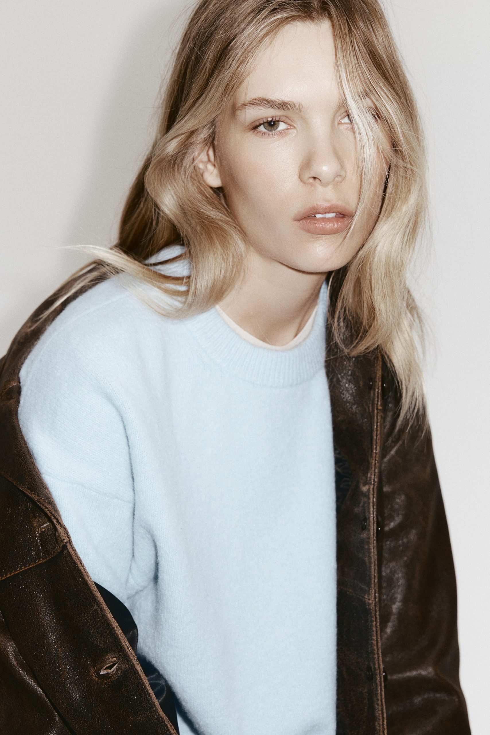 Textural Contrast: Light Blue Sweater under Leather Jacket Textural Contrast: Light Blue Sweater under Leather Jacket — Oversized Sweater Outfits