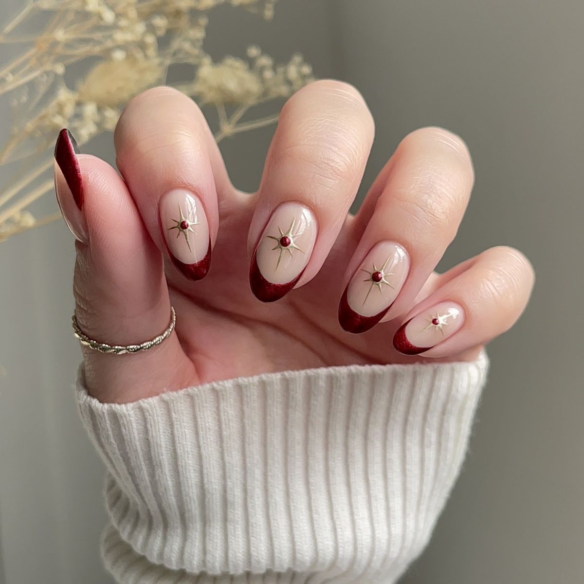 Nude French with Red Star Charms Nude French with Red Star Charms — Winter Nail Colors for Women Over 50