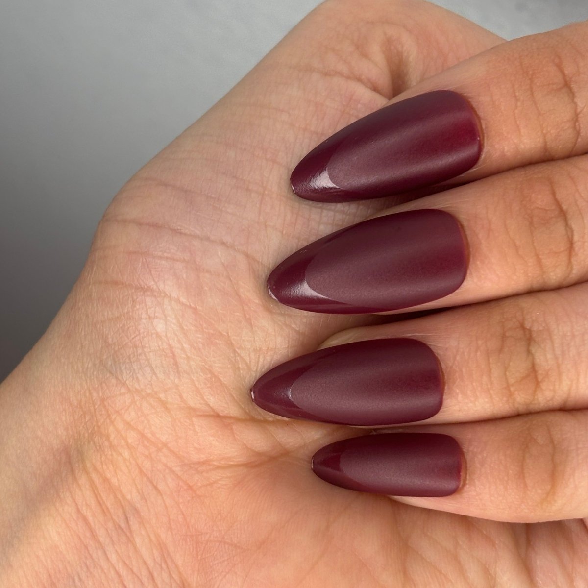 One Hand Close-Up Matte Burgundy With Glossy French Tips — Burgundy Nails