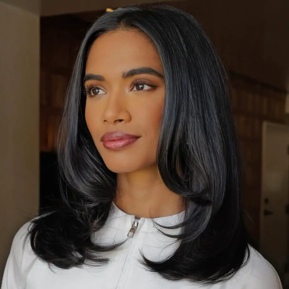 Voluminous Layered Hair with White Zip-Up Top Voluminous Layered Hair with White Zip-Up Top — Trendy Haircuts for Women