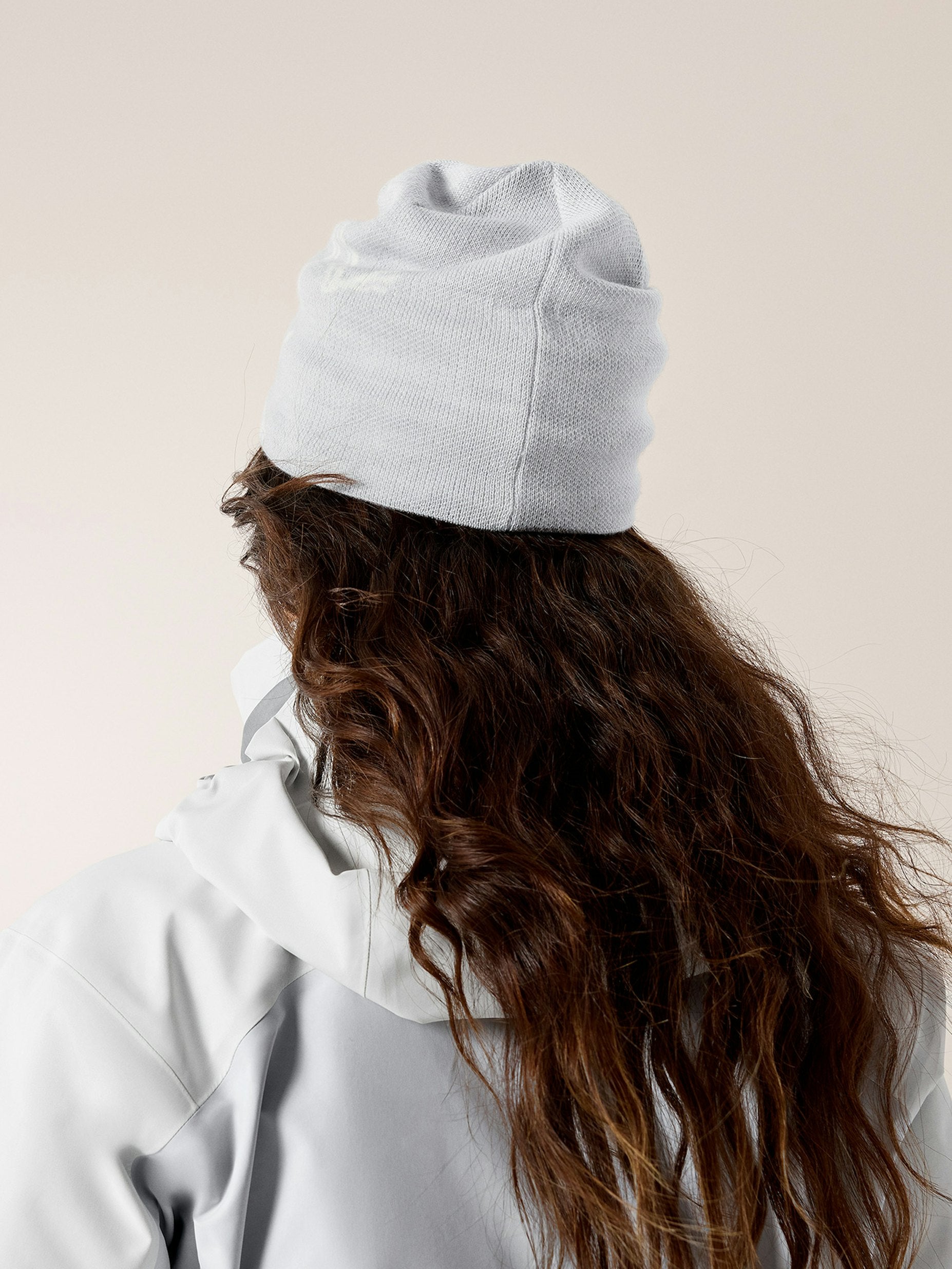 Thick Wavy Dark Brown Hair Under Blue Beanie — The Back View Of A Woman Displays Thick Thick Wavy Dark Brown Hair Under Blue Beanie — The Back View Of A Woman Displays Thick — Winter Hat Hairstyles