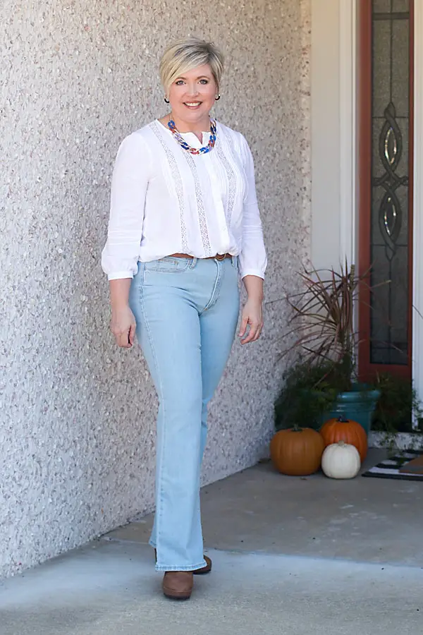 Light Wash Flare Jeans with Lace-Detail Blouse and Statement Necklace — Casual Winter Outfits for Women Over 50