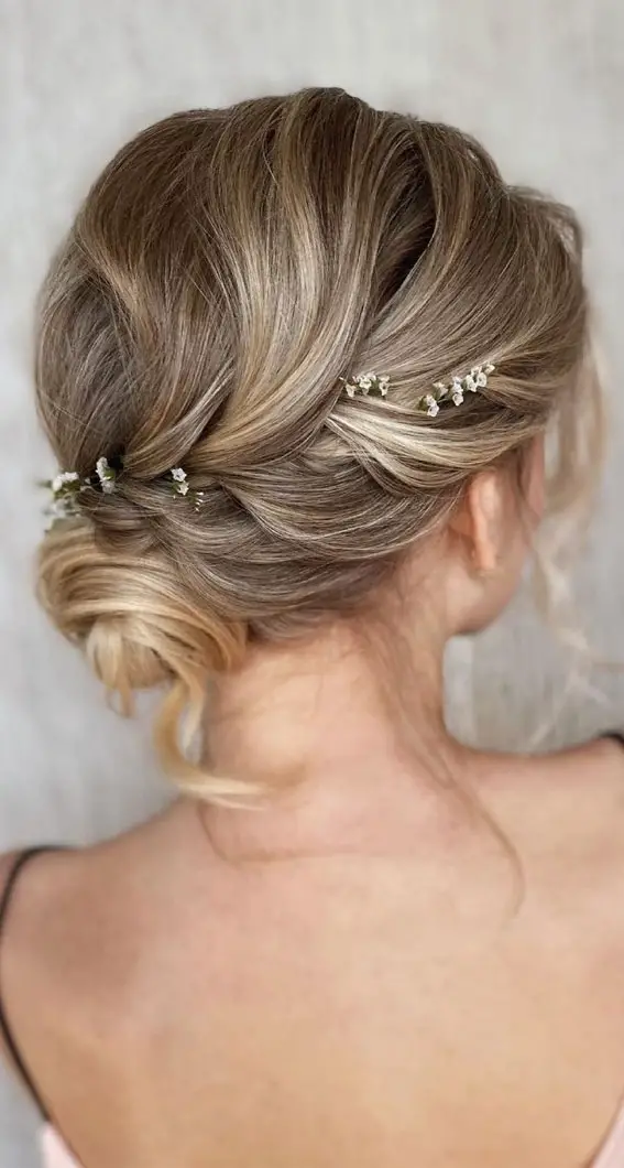 Ash Blonde Twisted Low Updo With Floral Accents — Winter Formal Hairstyles