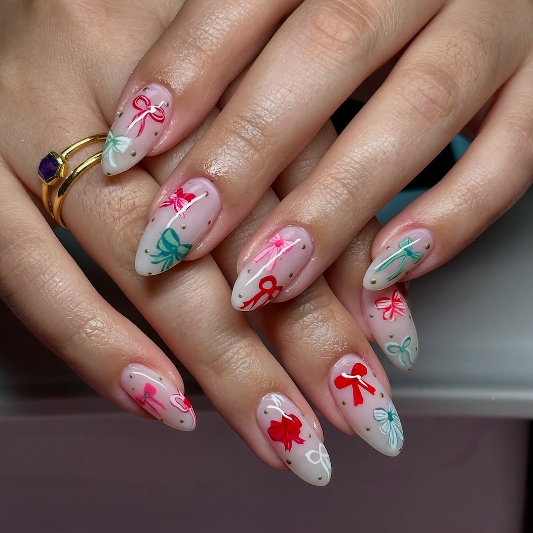 Medium Almond Clear Base with Painted Bows Medium Almond Clear Base with Painted Bows — Winter Vacation Nails
