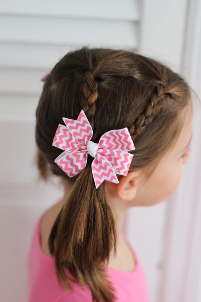 Small Braids Into Low Ponytails With Bow — Winter Hairstyles for Kids
