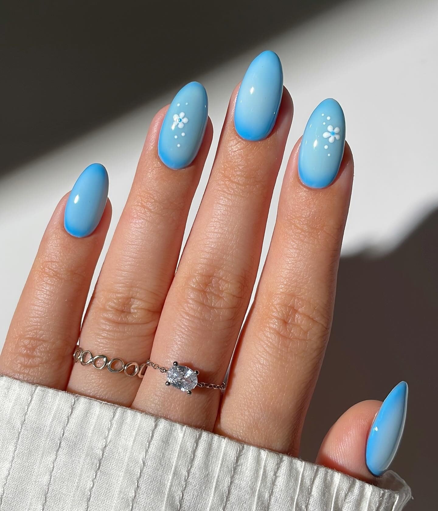 Bright Blue Ombre with White Floral Designs Bright Blue Ombre with White Floral Designs — Icy Blue Nails