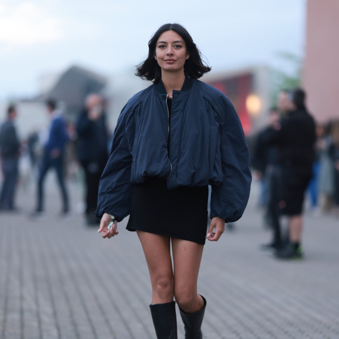 Oversized Bomber Jacket Over Mini Skirt and Black Boots — Knee High Boots Outfits