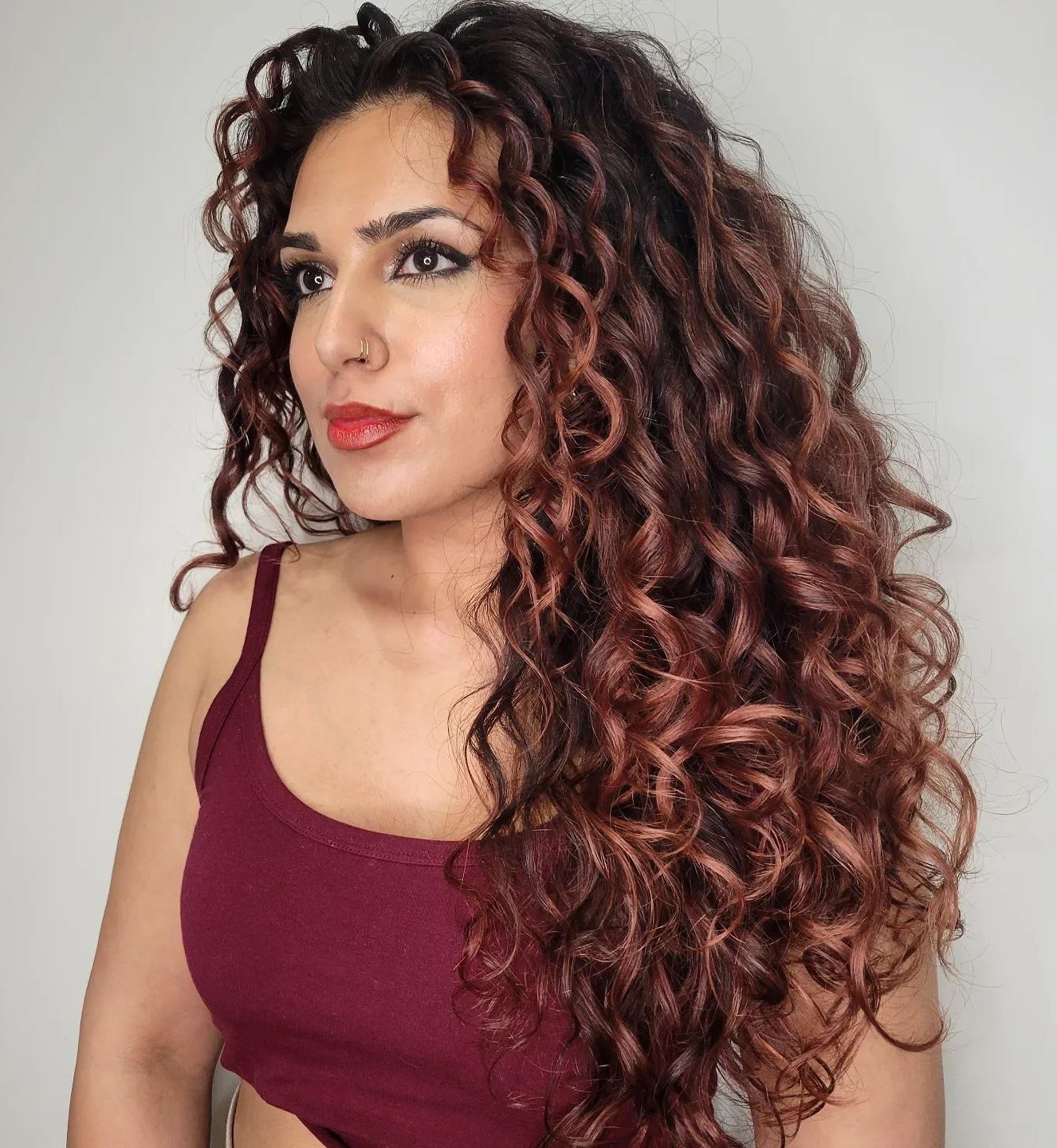 Mid-Back Curly Dark Brown With Auburn & Rose Gold Highlights Mid-Back Curly Dark Brown With Auburn & Rose Gold Highlights — Winter Hair Colors for Curly Hair