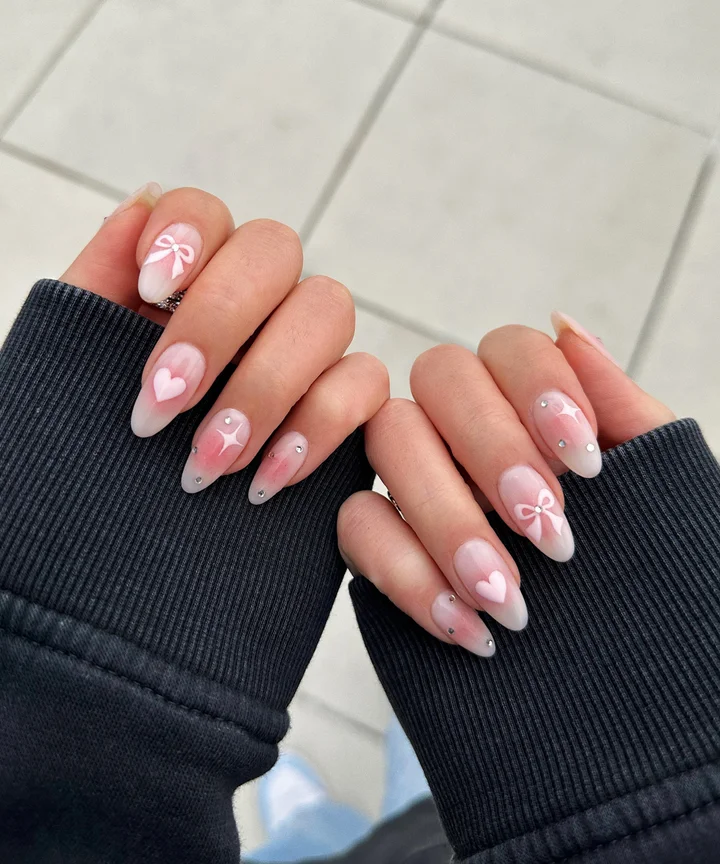 Sheer Pink Hearts Bows Rhinestones Sheer Pink Hearts Bows Rhinestones — Winter to Spring Transition Nails