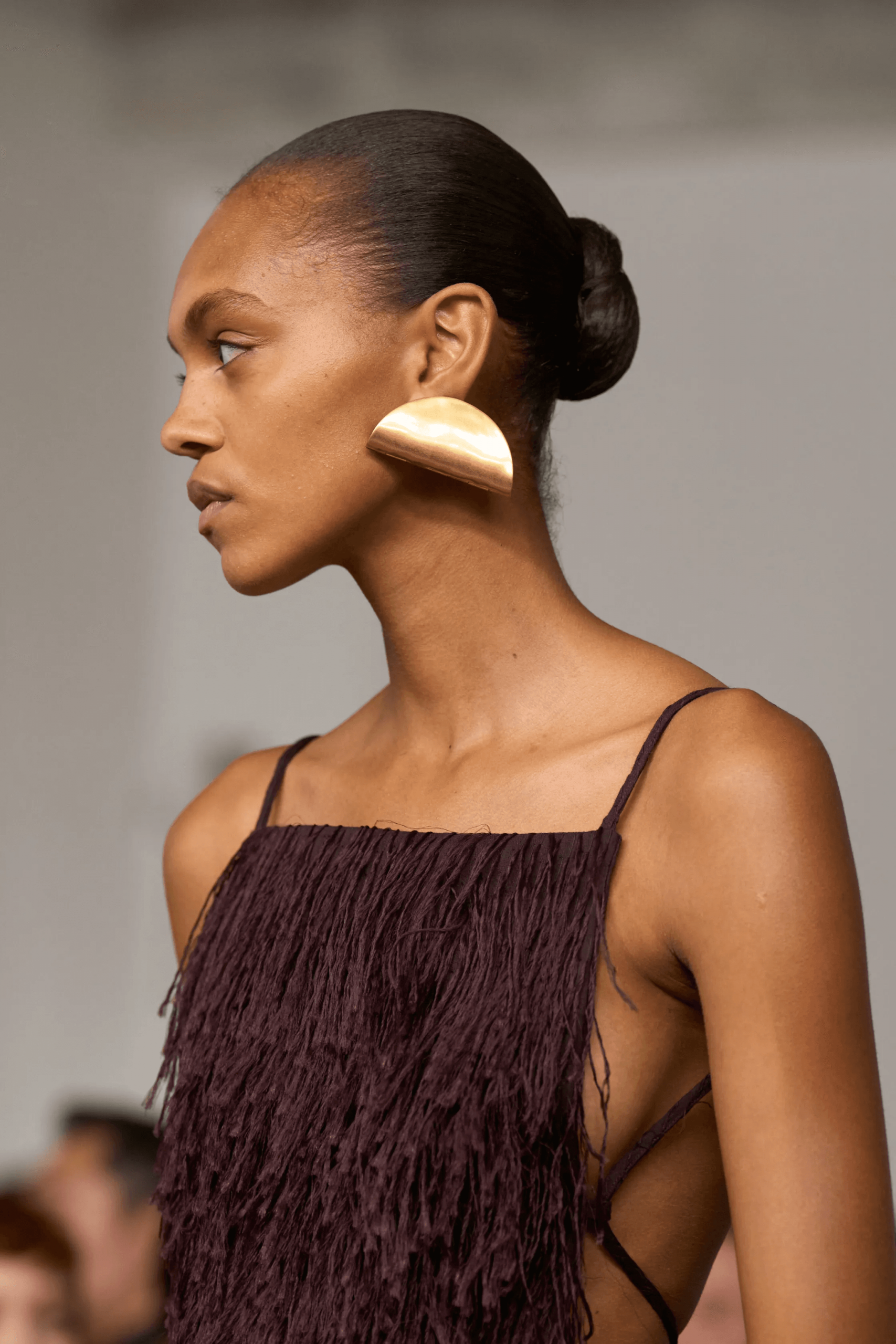 Slicked-Back Bun with Plum Fringed Dress and Gold Earrings Slicked-Back Bun with Plum Fringed Dress and Gold Earrings — Trendy Haircuts for Women