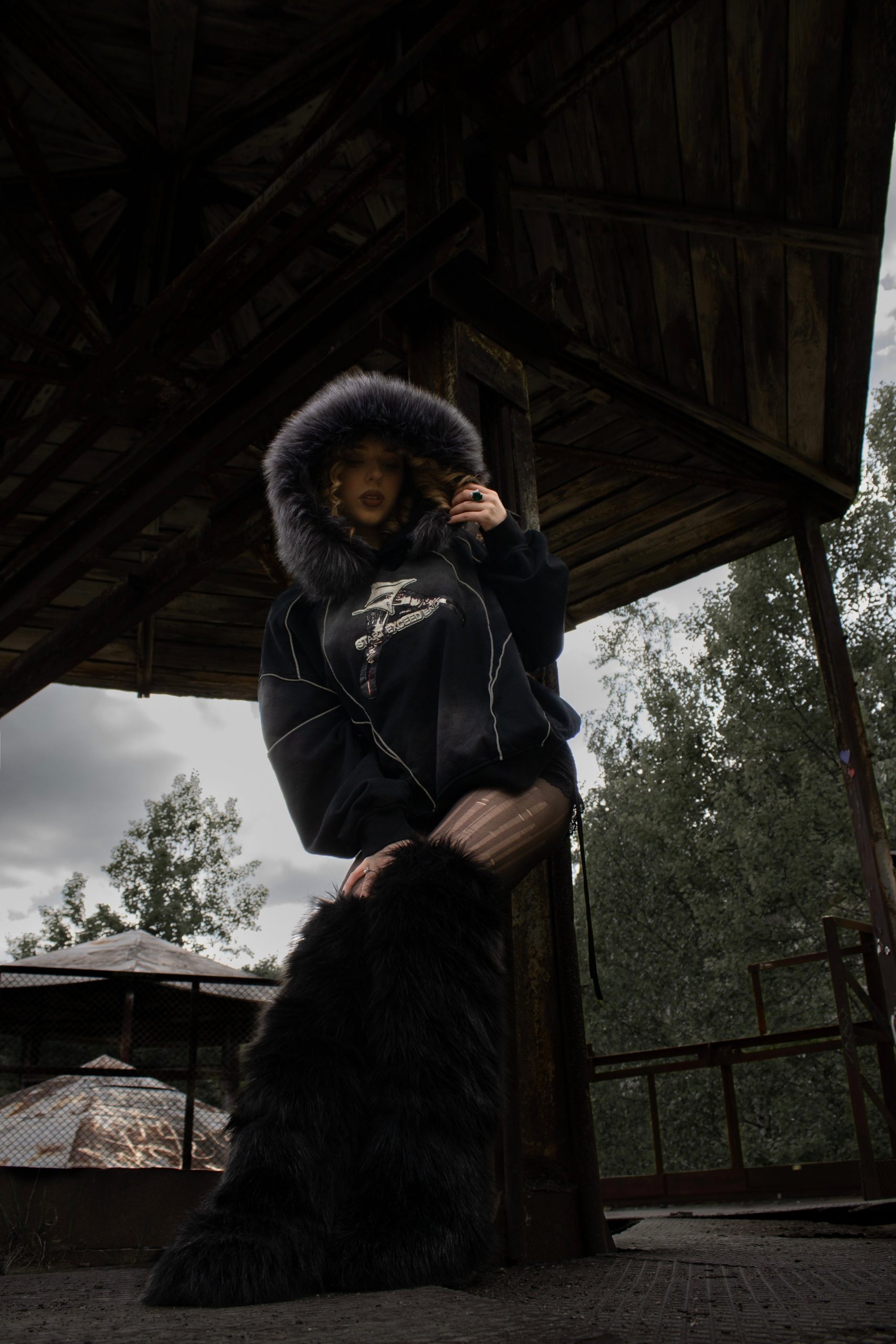 Oversized Graphic Hoodie with Fur-Lined Hood and Striped Tights — Grunge Winter Outfits