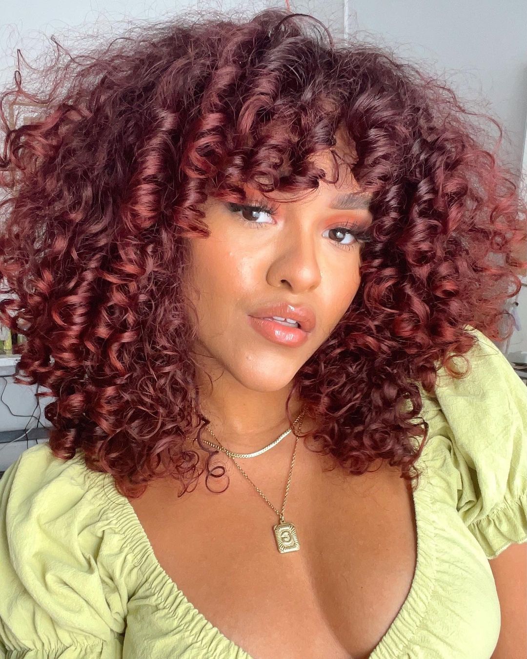 Deep Auburn With Voluminous Curtain Bangs Deep Auburn With Voluminous Curtain Bangs — Winter Auburn Hair Color