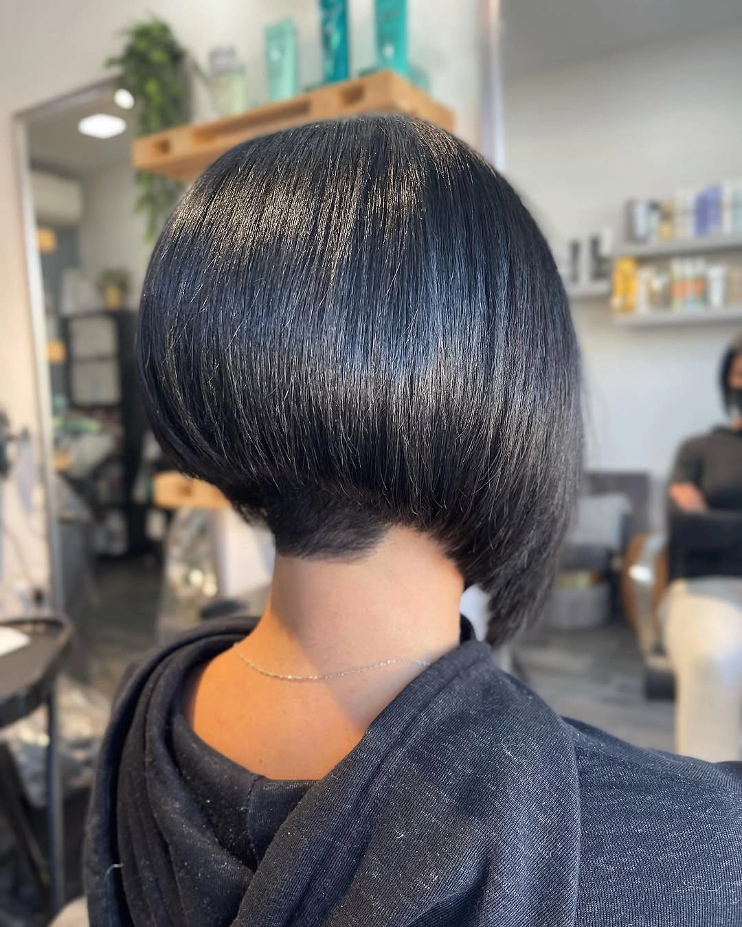 Glossy black short bob with rounded back and tight nape