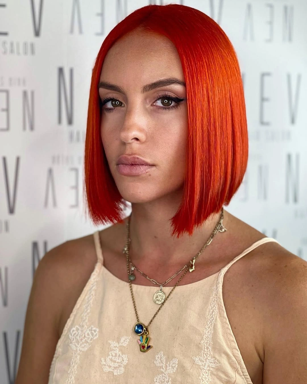 Bright orange red bob with center part and blunt ends