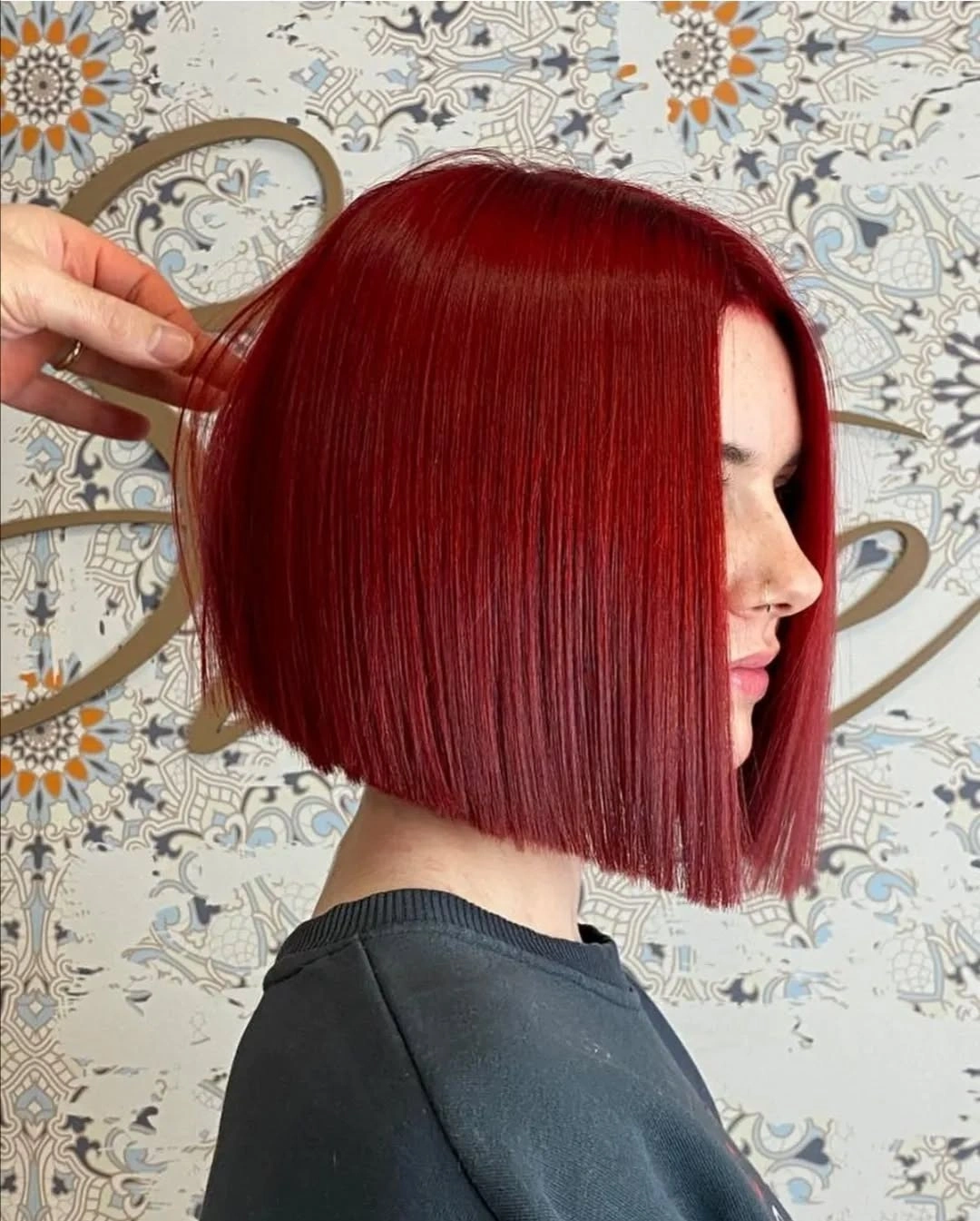 Vivid red straight bob with blunt side profile