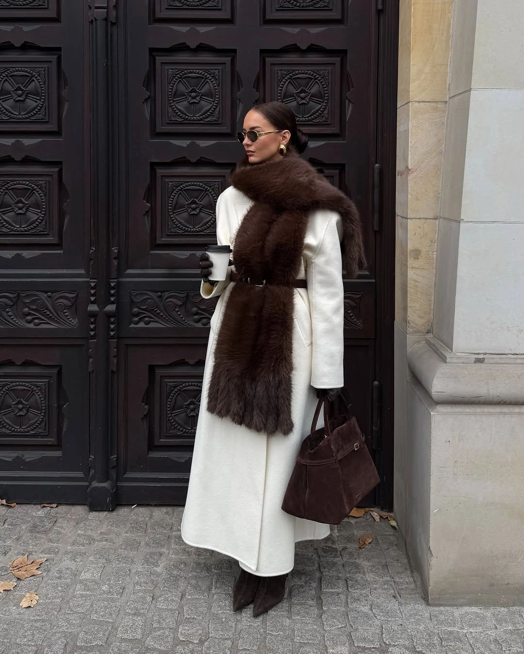 Ivory long coat dark brown neck layer black knee boots and brown handbag