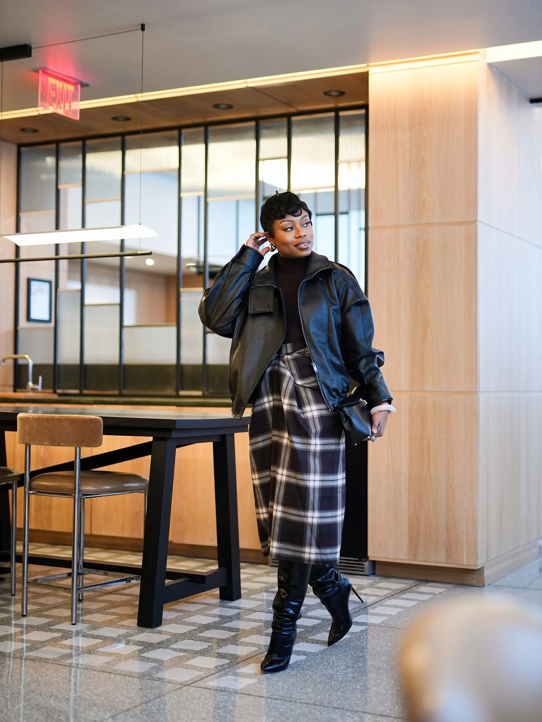 Dark cropped jacket black white plaid long skirt black boots and sunglasses