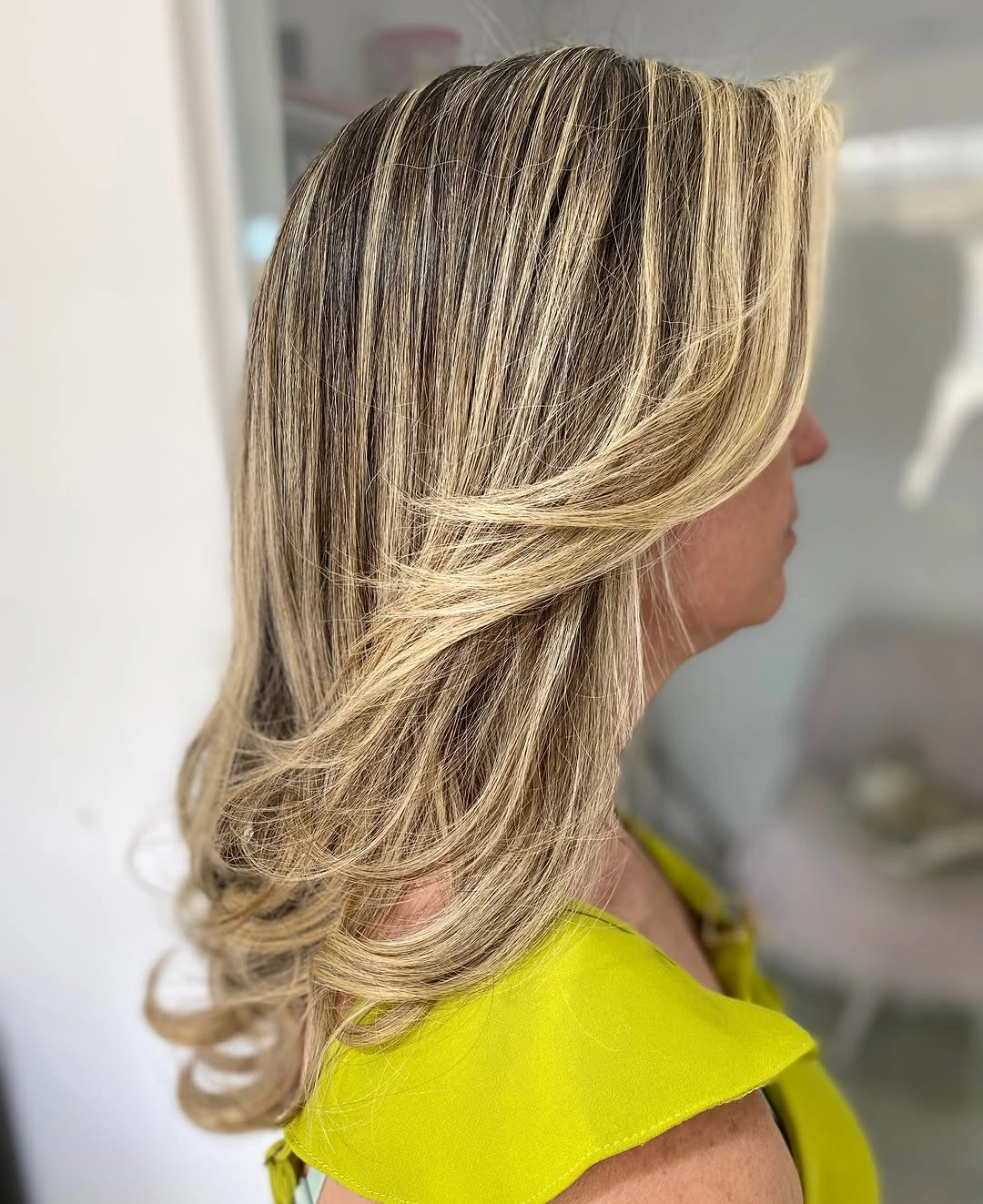 Layered darker blonde hair with bright blonde ribbons