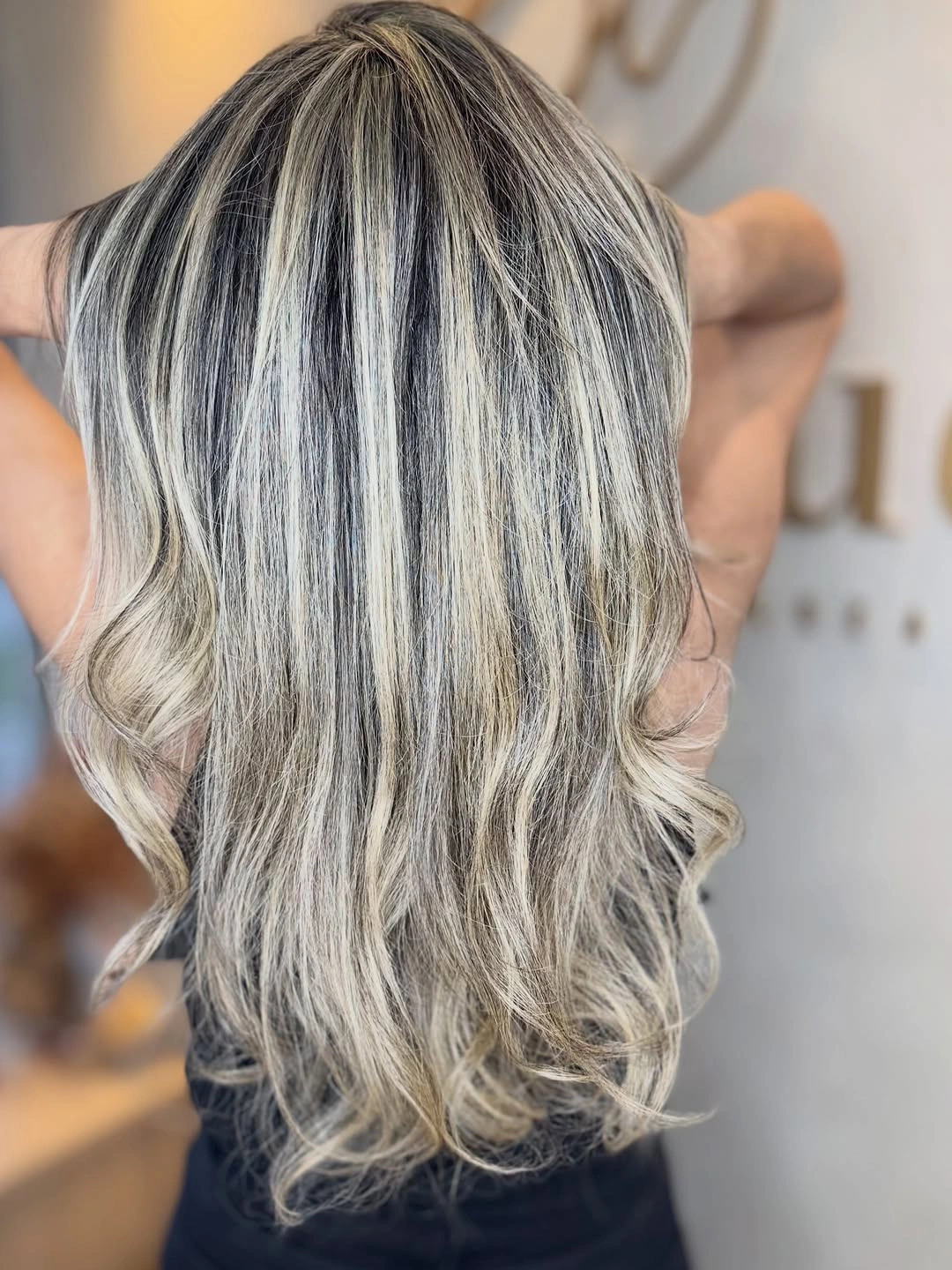 Back view of dark hair with silver-blonde ribbons