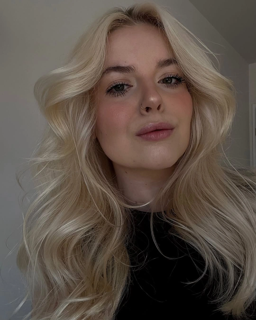Long creamy blonde waves with soft face-framing pieces