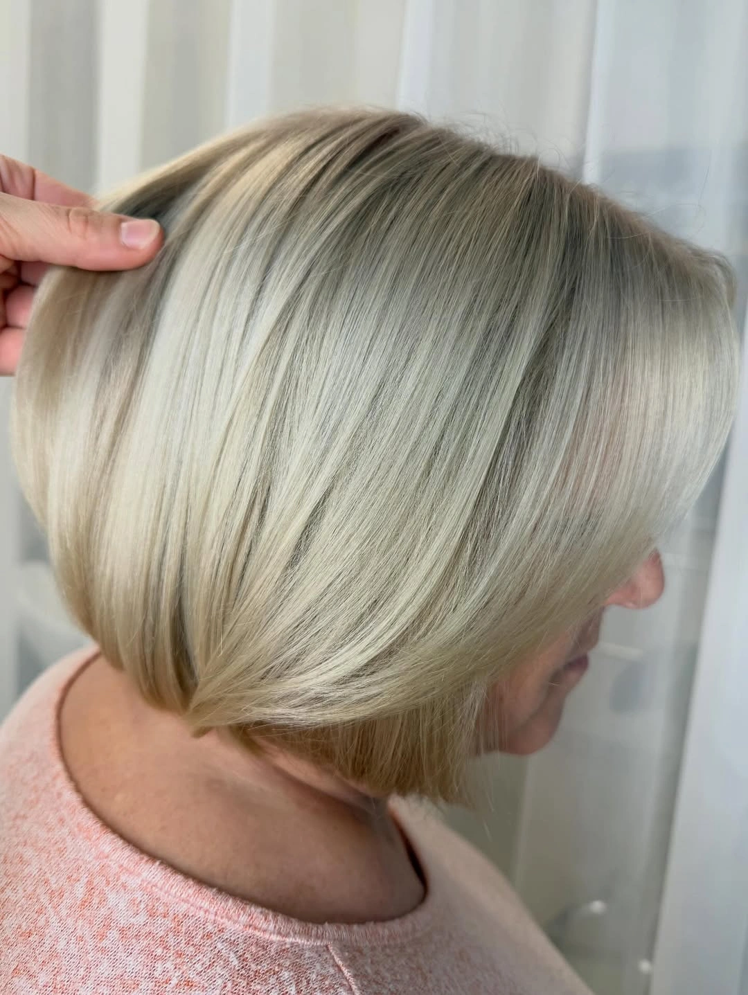 Side view of rounded sandy beige blonde bob