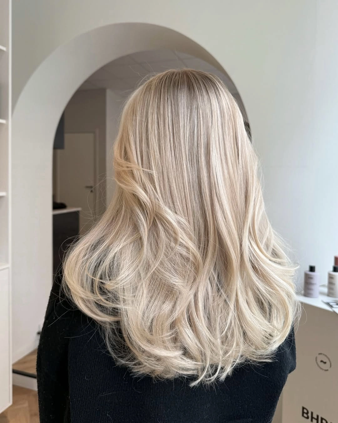 Back view of long beige blonde hair with loose waves