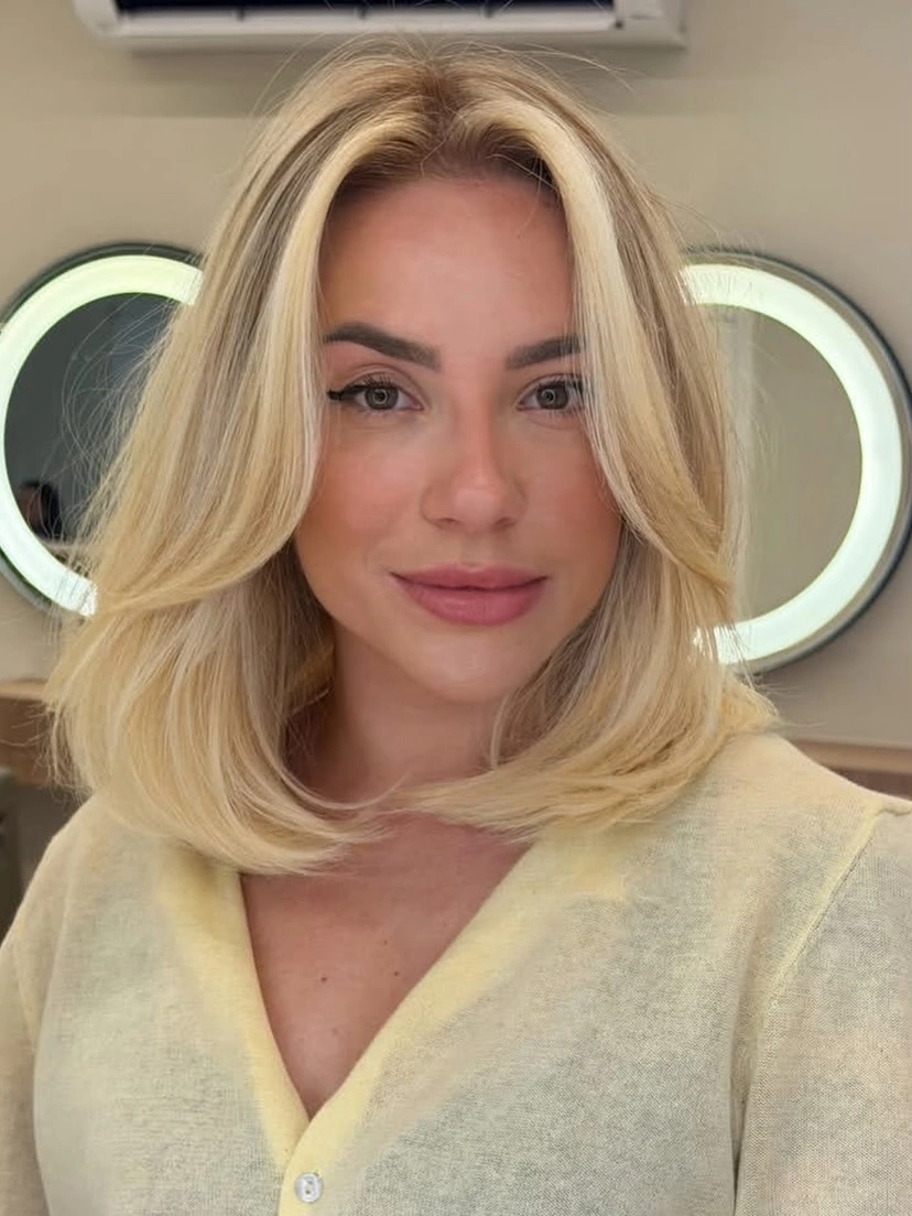 Medium buttery blonde hair with rounded face-framing layers