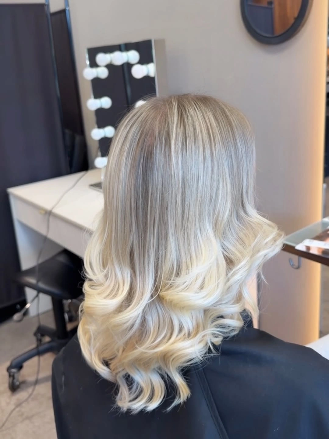 Medium blonde hair with ash top and curled creamy ends
