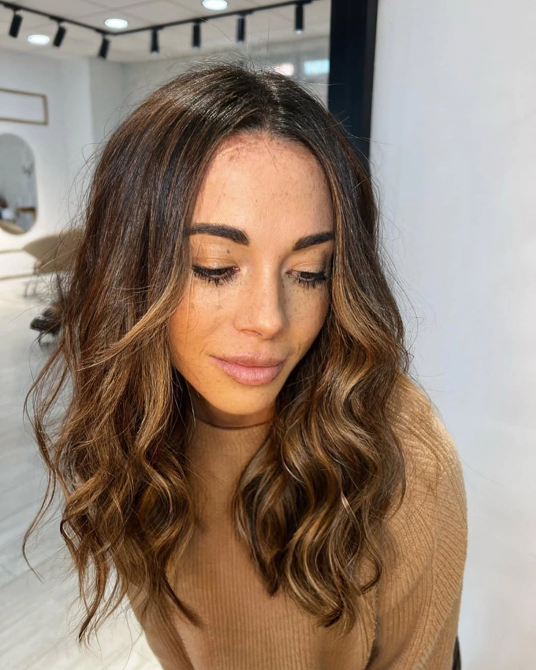 Medium brunette waves with caramel-copper face ribbons