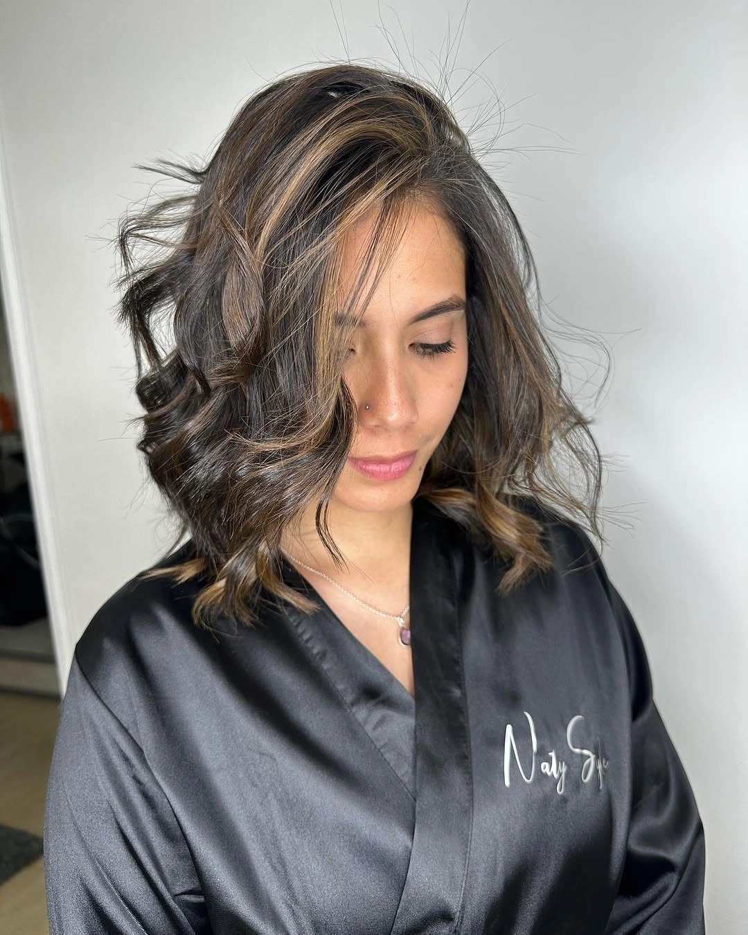 Short wavy brunette bob with bright front strip