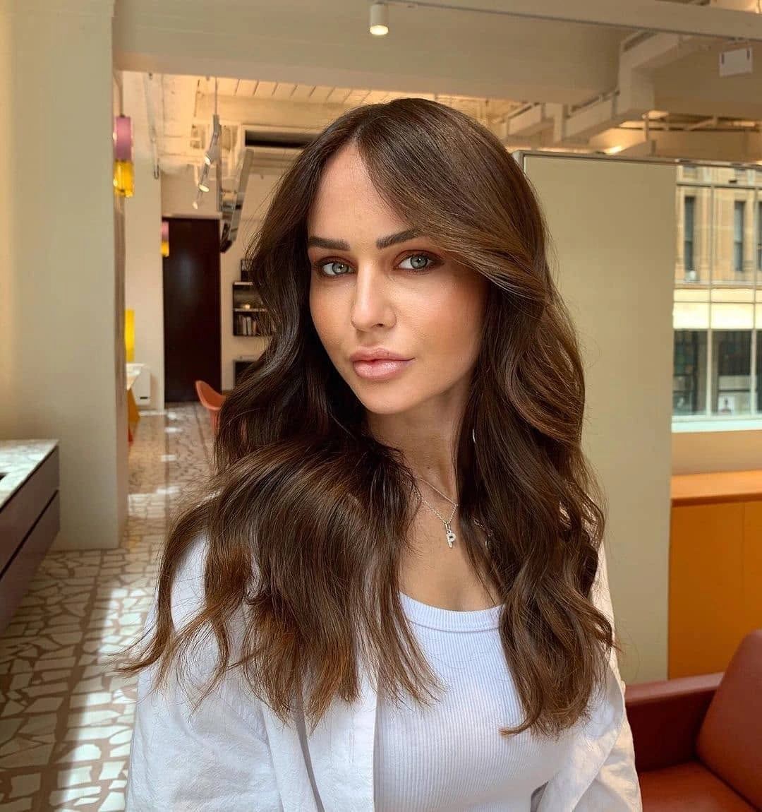 Medium-long chocolate brunette waves with soft warm ribbons